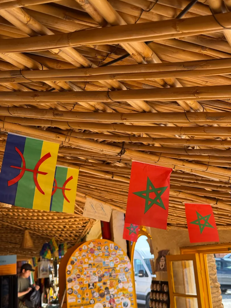 Moroccan flags and Amazigh flags for sale side by side in a Marrakech shop