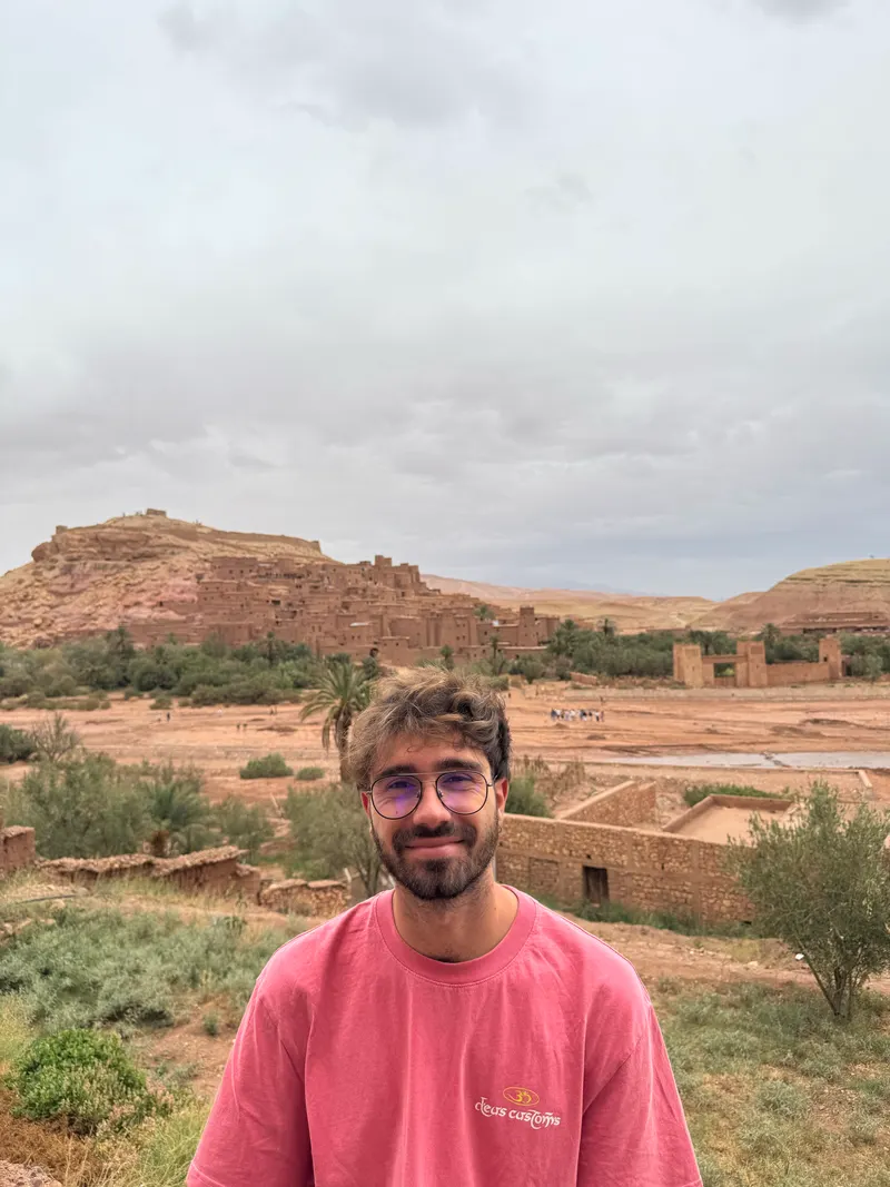 Standing with Ait Ben Haddou's kasbah in the background