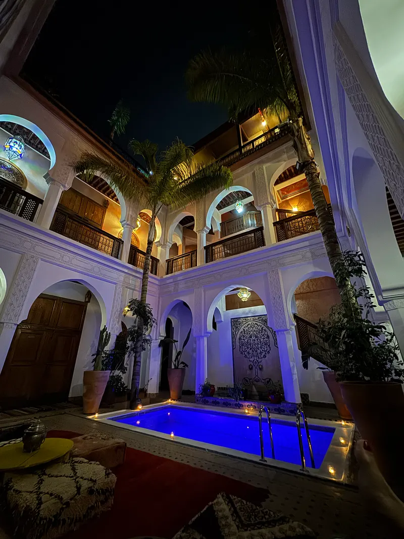 Riad Agdal Royal's lit-up pool at night, Marrakech