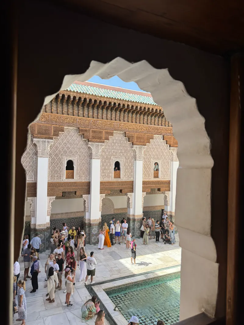 Geometric arch and tilework in Madrassa Ben Youssef's courtyard