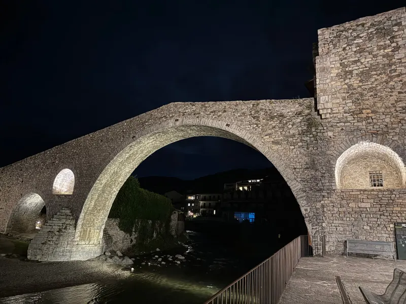 Camprodon's medieval bridge lit up at night