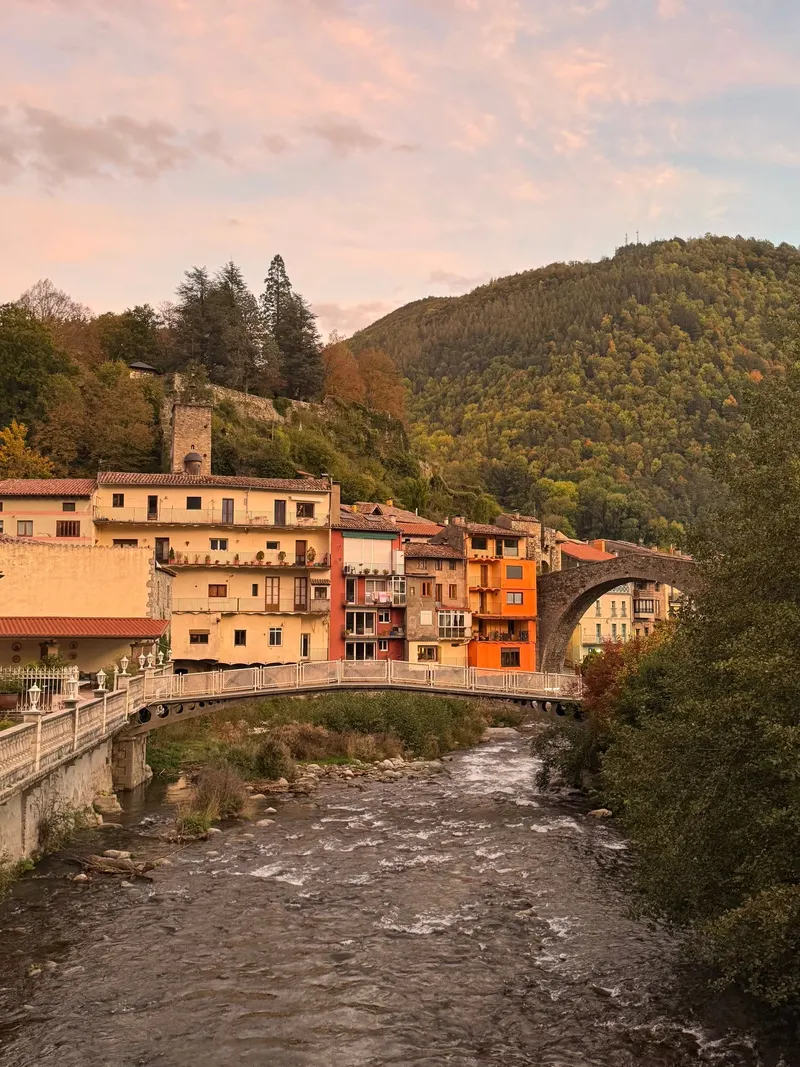 Camprodon at golden hour with the bridge, the river and the clock tower