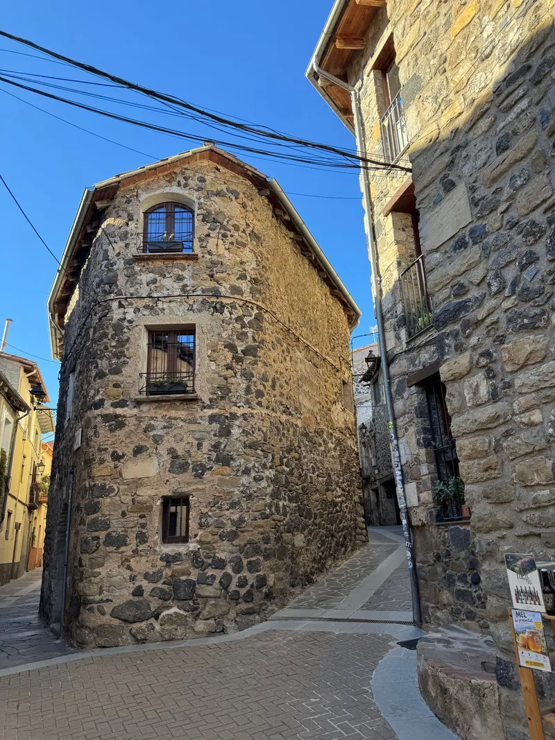 Two stone houses on a street in Castellfollit de la Roca
