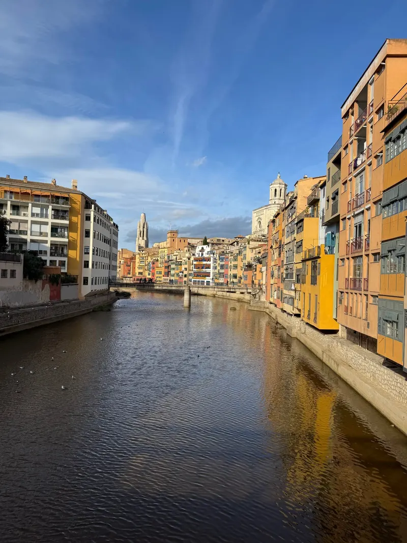 Colorful houses along the Onyar river seen from Girona's red bridge