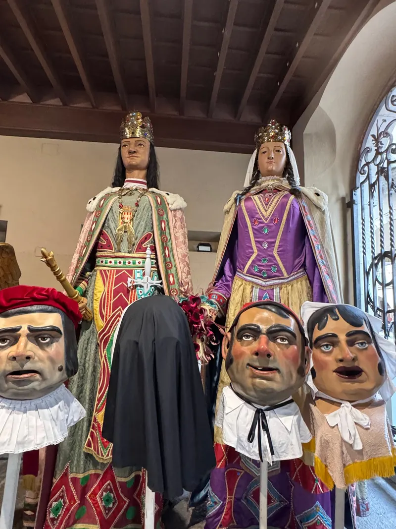 Gegants and capgrossos festival figures inside Girona town hall, ready for Sant Narcís