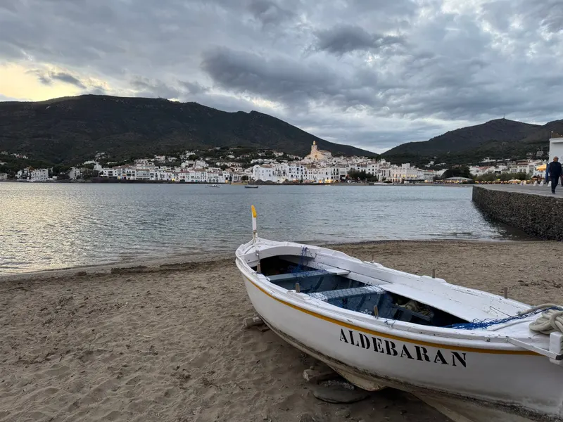 Cadaqués seen across the bay with a boat in front