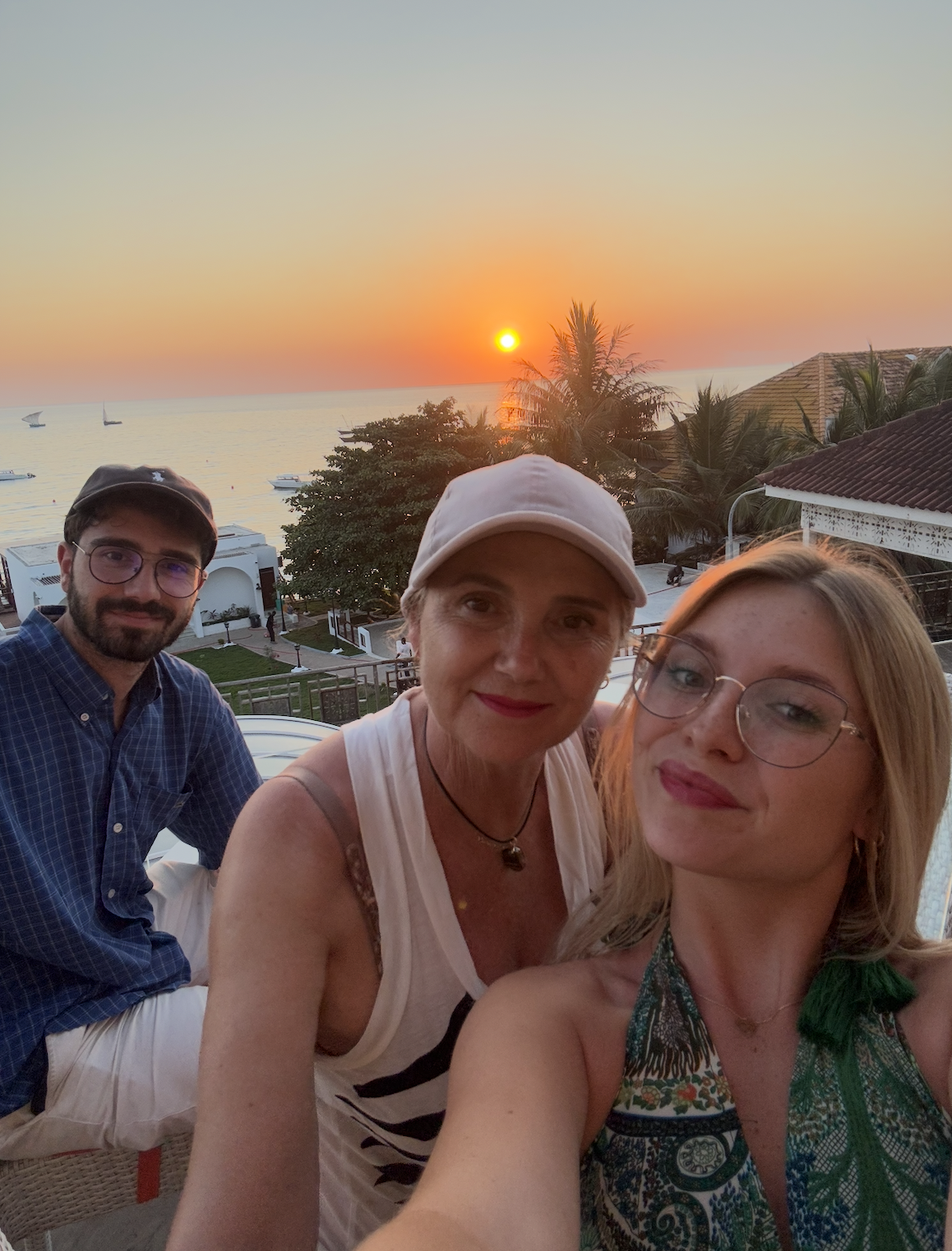Selfie holding cocktails, beautiful sunset in the background Stone Town Zanzibar